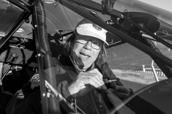 A pilot laughing in the cockpit
